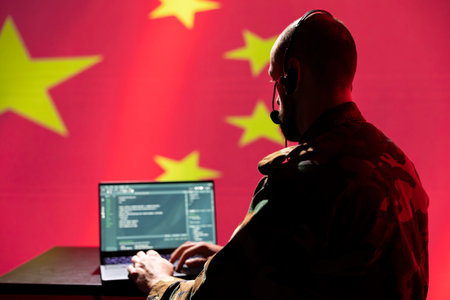 Engineer making troll accounts on social media promoting ideology. Software developer wearing headset building algorithms to spread government doctrineの写真素材