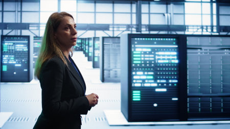 Engineer walking in data center workspace, monitoring systems to identify root cause of errors....