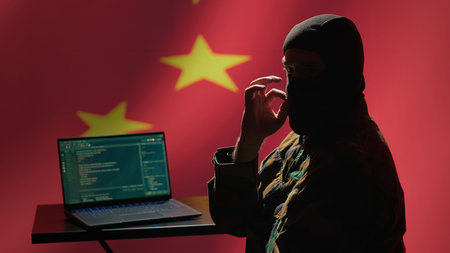 Person using software algorithms on laptop, wearing a mask and sharing malware online, camera A