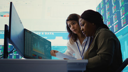 Company employees exchanging project details and big data to help in achieving business objectives, establishing budget and resources. Management team sharing information. Camera B.の写真素材