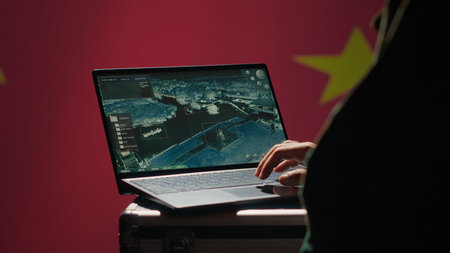 Chinese soldier in command control room using military tech to identify threats from enemies. Army personnel using software on laptop to communicate information to generals on war front line, camera Aの写真素材