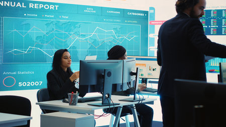 Financial manager briefing his team members about new corporation objectives, presenting their budget scheme with expenses. Resource allocation and project planning in control room. Camera A.の写真素材