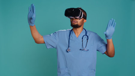 Nurse wearing virtual reality headset remotely operating patient. Healthcare specialist using high tech futuristic modern medical vr gadget, isolated over blue studio background, camera Bの写真素材