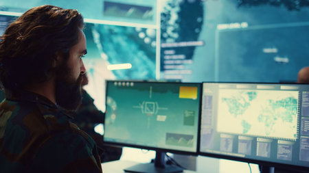 Army IT professional examining national satellite surveillance footage, transmitting real time important information from base to the general headquarters. General of the navy operations. Camera B.の写真素材