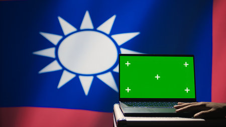 Taiwan specials ops unit uses green screen laptop to counteract Chinese propaganda promoting CCP One China policy. Taiwanese insurgent advocates for independence online using mockup notebook, camera Bの写真素材
