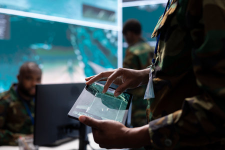 Army intelligence specialists using advanced computer systems and satellite data to enhance national...