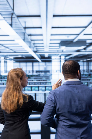 Team of technicians in data center tracking network traffic and activity, installing and configuring...
