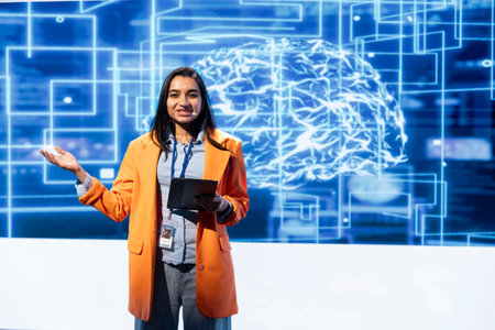 Cheerful engineer holding presentation at AI tech summit event gathering professionals using tablet. Jolly speaker using device to present how can AI be leveraged to accelerate innovationの写真素材