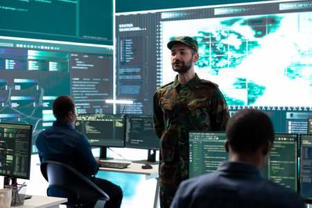 Military personnel working in a government cyber defense center, cyber attack prevention. Soldiers team securing sensitive data from spyware, ransomware and other malware threats.の写真素材