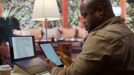 Corporate owner drafting architectural sketches for a new office, looking to relocate startup headquarters. Collaborating with contractors to design a functional and creative workspace. Camera B.の写真素材