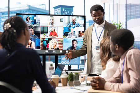 Company employees attending a meeting via videocall with investors, discussing about the future of the enterprise. Advisory board and workers examining infographics data for management.の写真素材