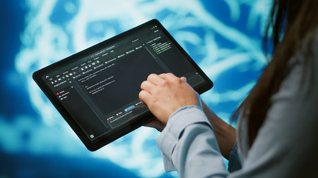 Programmer using tablet to maintenance artificial intelligence neural networks. Close up shot of...