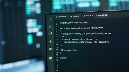 Computers in server hub used to ensure optimal performance and reliability, managing mainframes. Close up of code running on PC display in high tech data center used for overseeing network connectionsの写真素材