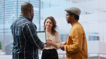 Real estate investment expert and entrepreneur planning an office space relocation, examining blueprints and discussing the layout for the new workspace. Looking to buy urban property. Camera B.の写真素材
