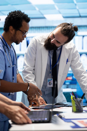 Healthcare professionals examine human anatomy scans to develop treatment plans, teamwork and expertise in radiology. Medical specialists work on analytics and diagnostics at private clinic.の写真素材