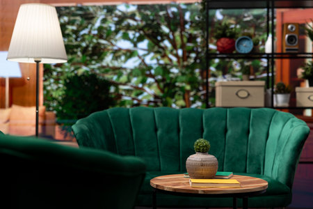 Cozy empty home interior with elegant green chairs and wooden table, light filled space. Modern furniture and panoramic windows overlooking the forest. Scandinavian style cabin in the woods.の写真素材