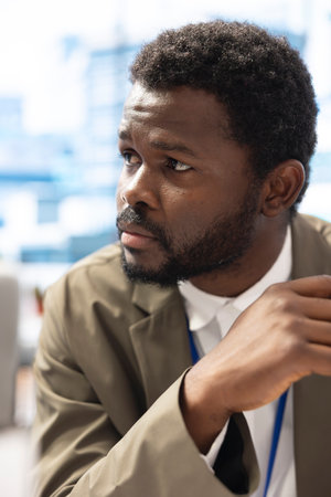 Management team gathering in the boardroom to review key performance indicators, discussing project strategy in order to achieve goals. Shareholder listening to infographics presentation.の写真素材