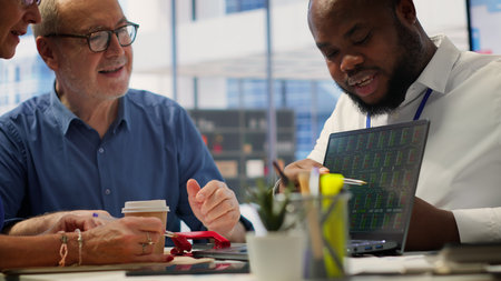 Elderly couple consulting with a financial advisor to create a detailed retirement plan, focusing on...