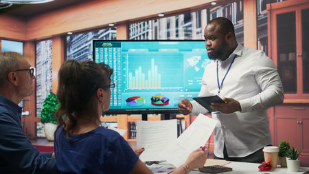 Broker advisor highlighting and pointing out important terms of a contract, middle aged people negotiating with financial expert for a retirement plan and pension option. Camera B.の写真素材