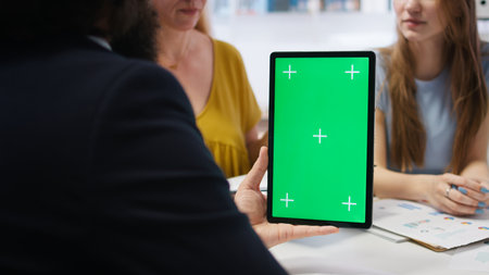 Financial adviser assisting clients in setting up investment accounts with green screen tablet, conducting audit. Consultant uses financial planning software on mockup device to help family, camera Aの写真素材