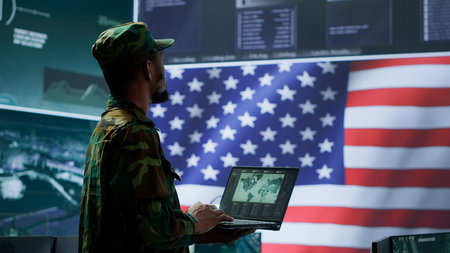 US soldiers operating in a high tech cybersecurity command post, managing state secrets and classified information. Protecting servers against digital threats and cyber warfare. Camera A.の写真素材