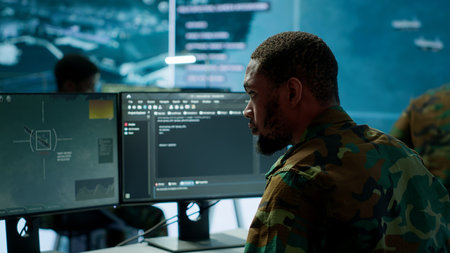 Soldier working with AI intelligence on pc in control room, processing live data on cctv systems. Surveillance efforts to support field missions and defense operations, national security. Camera A.の写真素材