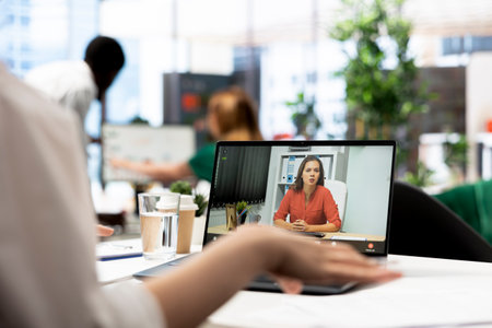 HR manager interviewing woman during remote videocall after doing background checks. HR professional...