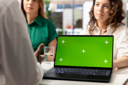 Employers using green screen laptop to find qualified candidates through job postings, using recruiting tools. HR coworkers using mockup notebook to identify employees to get hired for companyの写真素材