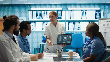 Diverse medical team examining test results and discussing innovative treatment plans at a modern...