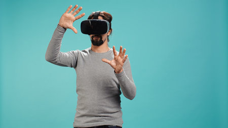 Man wearing virtual reality headset, interacting with interface, doing swiping motions. Person...