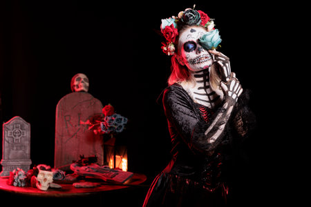 Girl performing witchcraft at Dia de los Muertes indigenous rites of honoring the dead. Woman with...