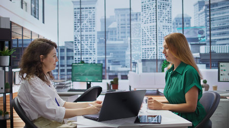 Female recruiter holding an interview with a job applicant in high end office, looking to fill in...