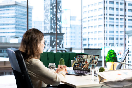 Ambitious influential businesswoman mentors young professionals on teleconference, sharing her...