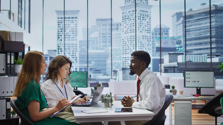 Team of employers questioning a job applicant during an interview within the HR department office,...
