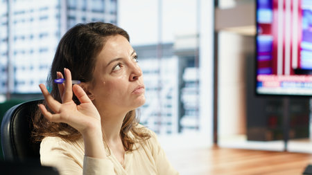 Successful entrepreneur doing research for a global business expansion, developing her enterprise in a high end office. Leader with work ethic and strategic thinking achieving targets. Camera A.の写真素材