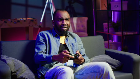 Irked gamer annoyed after losing in online singleplayer videogame played using controller. Man...
