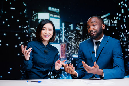 Team of newscasters on night tv show transmitting live information from media outlets and...