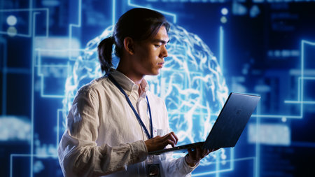 Capable IT contractor works with artificial intelligence computerized model simulating human brain. Tech support man looks at AI visualization of machine learning algorithms using pattern recognitionの写真素材