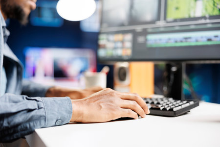 African american freelancer working on movie montage project, creating new white balance and...