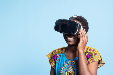 Female model using virtual reality headset futuristic tech in studio, playing with modern innovative...