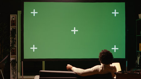 Man watching sports competition live on ultrawide mockup smart TV, cheering for favorite team. Cord...