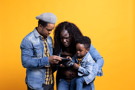 African american parents in debt struggling with money and expenses for childcare, looking for ways to increase family income and savings. Mom and dad being worried about financial difficulties.の写真素材