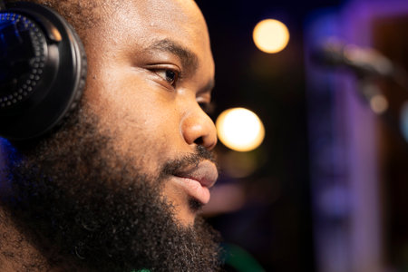 Talented music producer editing audio files with console and stereo gear, mixing and mastering...