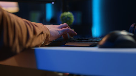 Focus on computer peripherals used by programmer to write lines of code on PC screen. Close up shot of keyboard and mouse used by developer working on fixing database errors, camera Aの写真素材