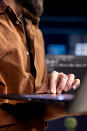 Developer at home typing on laptop to fix vulnerabilities in software enabling attackers to compromise systems. IT expert taking care of security exposures in operating system, close upの写真素材