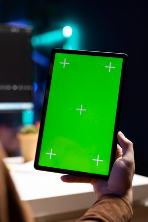 Programmer using isolated screen tablet to fix vulnerabilities in software, close up. Man taking care of security exposures in operating system, writing code on chroma key portable deviceの写真素材