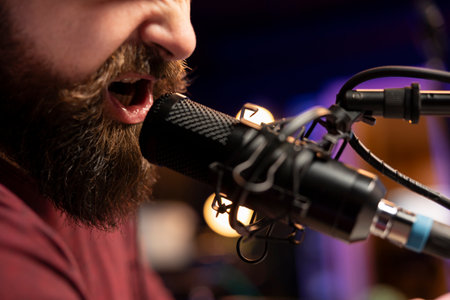 Professional composer singing a song on microphone to create tunes with mixing and mastering...