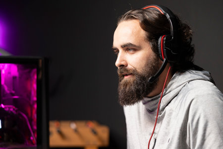 Streamer in RGB lit apartment chatting with audience, providing them with useful gaming insights....