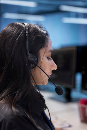 IT support personnel working in call center, providing outsourcing services for data centers. Woman...