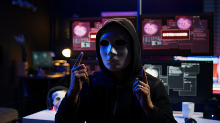 Focus on camera on phone on tripod used by hacker concealing identity filming ransom video in hidden...
